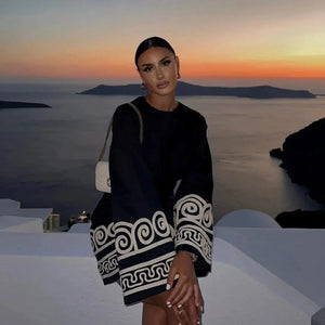 Schwarzes Minikleid mit weiten Ärmeln, griechischem Muster, von Frau getragen | Fashion Peak