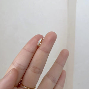 Goldener kleiner Creolen-Ohrring mit Zirkonia, getragen an weiblicher Hand | Fashion Peak