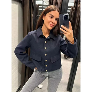 Frau trägt kurze dunkelblaue Utility-Jacke mit Kragen und Knöpfen, Jeans | Fashion Peak